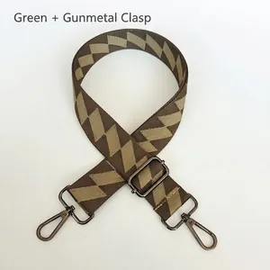 Detail of adjustable geometric green and brown bag strap with gunmetal swivel hooks