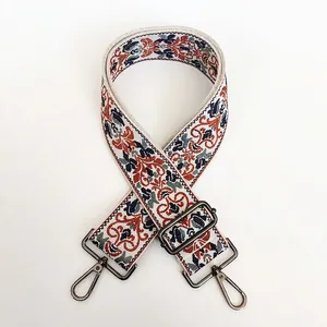 Detail of vintage floral jacquard bag strap with adjustable gunmetal lobster buckles