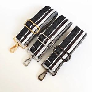 Detail view of 5cm wide striped adjustable bag straps with gold silver and gunmetal hardware