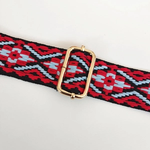 Close-up of woven geometric jacquard strap with gold adjustable metal buckle
