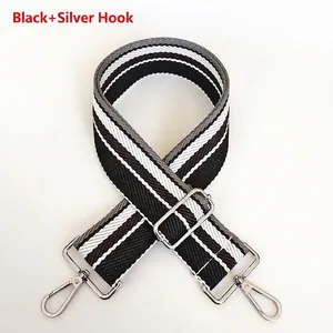 Close-up of adjustable 5cm wide striped bag strap with silver metal hooks and buckle