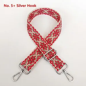 Detail of red and grey geometric pattern bag strap with silver metal lobster clasps
