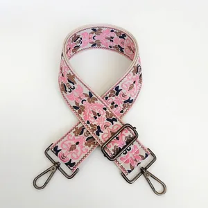 Detailed view of vintage floral jacquard woven shoulder strap with gunmetal metal hooks