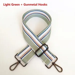 Close-up of 5cm wide striped bag strap with gunmetal hooks and adjustable buckle