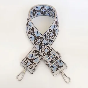 Close-up of vintage floral jacquard bag strap with silver metal swivel snap hooks