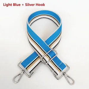 Detail of adjustable 5cm wide light blue striped woven strap with silver metal hooks
