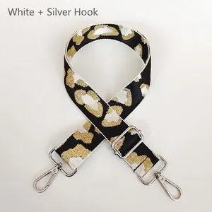 Detail of adjustable leopard print bag strap with silver metal lobster clasps and gold threads