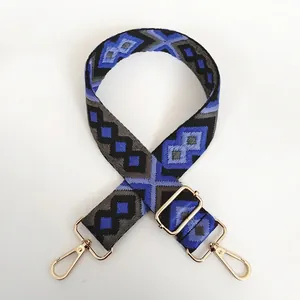 Adjustable wide canvas bag strap with blue ethnic geometric pattern and gold hooks