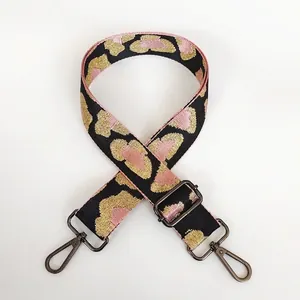 Detail view of adjustable leopard print shoulder strap with gunmetal hardware hooks