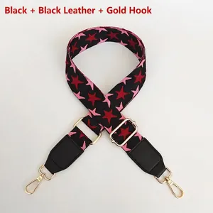 Adjustable bag strap with pink star pattern, black leather ends and gold metal hooks