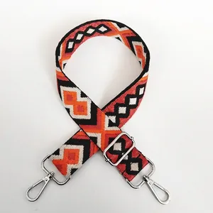 Detail of bohemian geometric rhombus pattern on woven strap with silver metal buckle