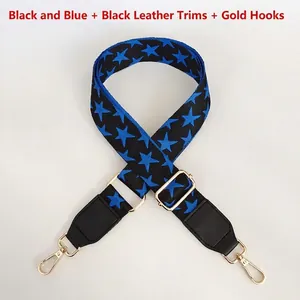 Close-up of jacquard bag strap with blue stars, black leather ends and gold metal hooks