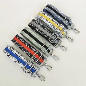 Detail view of six colorful patterned nylon replacement straps with silver metal buckles