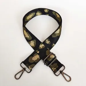 Detail of green leopard print wide strap with gunmetal hooks and adjustable buckle