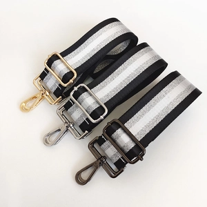 Detail showing adjustable striped bag straps with gold silver and gunmetal metal hooks