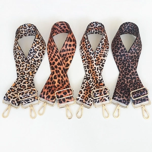 Detail of colorful leopard print shoulder straps with gold metal adjustment buckles and clips