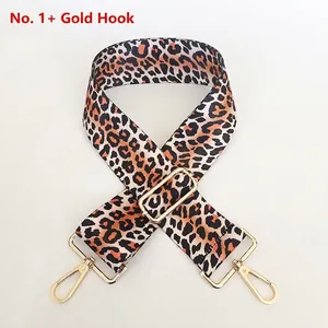 Detail of adjustable leopard print bag strap with golden metal spring hooks and buckle