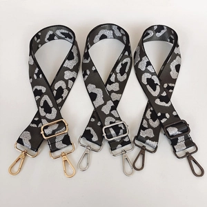Adjustable wide leopard print bag straps with gold, silver, and gunmetal hardware details