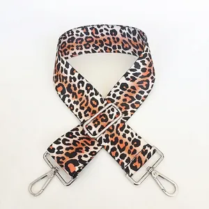 Close-up of leopard print shoulder strap with adjustable silver buckle and lobster hooks