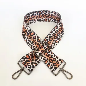 Close-up of adjustable leopard print shoulder strap with dark gray metal rotating hooks