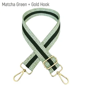 Adjustable matcha green polka dot fabric shoulder strap with gold metal lobster clasps