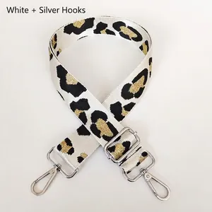 Close-up of adjustable leopard print bag strap with silver hooks and metallic gold texture