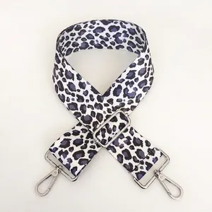 Close-up of leopard print shoulder strap with adjustable silver metal hooks and buckle