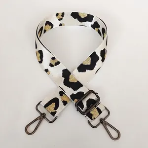 Close-up of leopard pattern strap with gold metallic thread and gunmetal hooks
