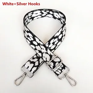Detail of white leopard print wide strap with adjustable silver metal hooks for handbags