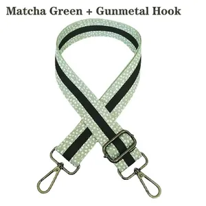 Close-up of adjustable matcha green polka dot bag strap with gunmetal swivel hooks