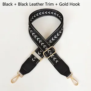 Close-up of adjustable black nylon strap with white chevron pattern and gold hooks