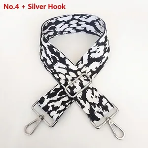 Detail of adjustable black and white leopard print strap with silver metal hooks