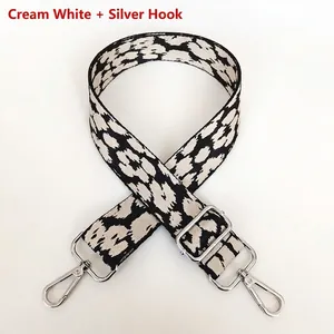 Detail of off-white leopard pattern strap with silver metal hooks for crossbody bags