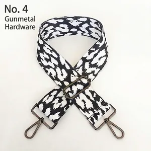 Close-up of leopard print bag strap with black hardware and adjustable metal buckle