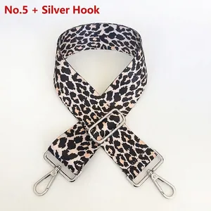 Detail of adjustable leopard print bag strap featuring silver metal climbing hooks