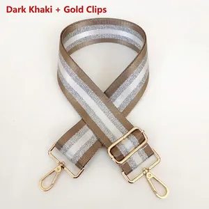 Detail view of dark khaki woven bag strap with silver glitter stripes and gold metal hooks