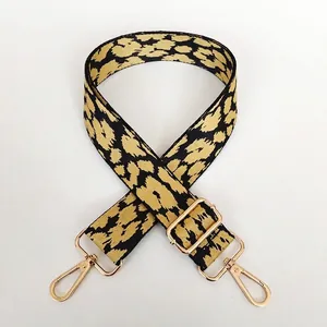 Adjustable leopard print bag strap with yellow canvas and polished gold metal hooks