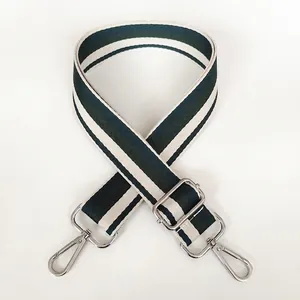 Detail of adjustable green and white striped canvas shoulder strap with silver hooks