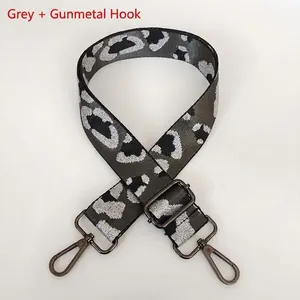 Detail of adjustable leopard print bag strap with grey metallic weave and gunmetal hooks