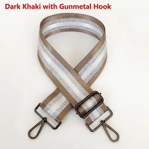 Detail of adjustable dark khaki striped bag strap with gunmetal swivel hooks