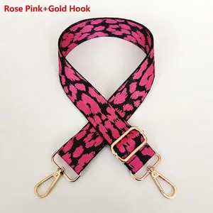 Adjustable leopard print handbag strap in magenta and black with golden metal hooks