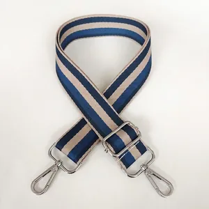 Detail of adjustable blue and beige striped wide strap with durable silver metal hooks