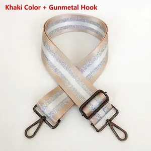 Detail of khaki striped bag strap with gunmetal lobster hooks and adjustable buckle