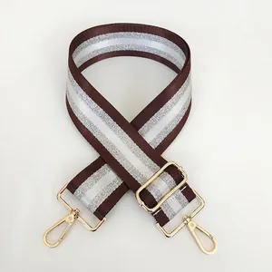 Adjustable coffee and silver striped bag strap with polished gold metal lobster clasps