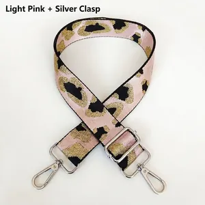 Detail of light pink leopard print woven strap with silver swivel hooks and adjustable buckle