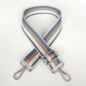 Detail of adjustable blue striped canvas shoulder strap with silver metal swivel hooks