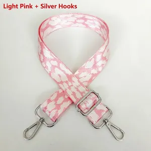Close-up of adjustable pink leopard print bag strap with silver metal hooks