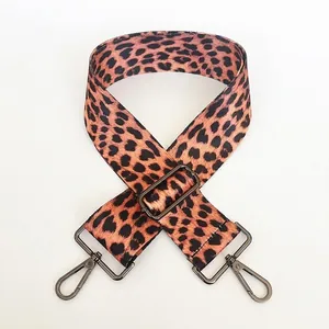 Close-up of leopard print shoulder strap with adjustable gunmetal swivel hook buckles