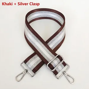 Detail of khaki striped bag strap with silver metal swivel hooks and adjustable buckle