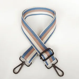 Detail of adjustable wide striped canvas bag strap with light blue and gunmetal hooks